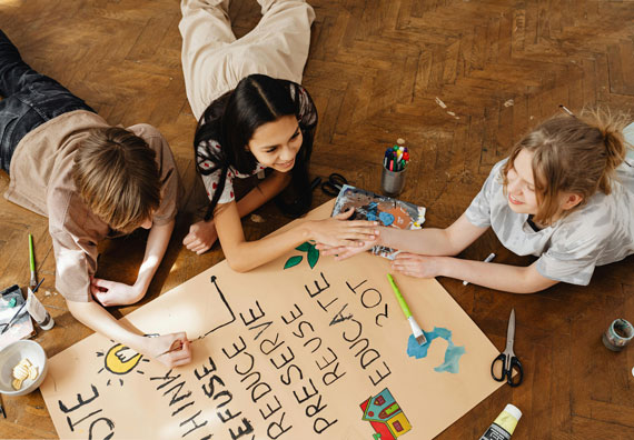 Photo of teens painting campaign poster