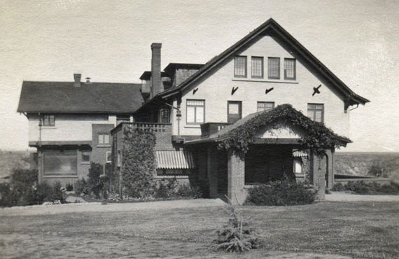 A historic photo of the Marston House with traditional striped awnings