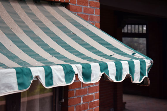 Photo of a faded, tattered Marston House awning