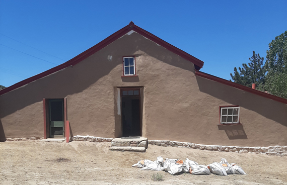 Photo of adobe mud plaster having been applied.