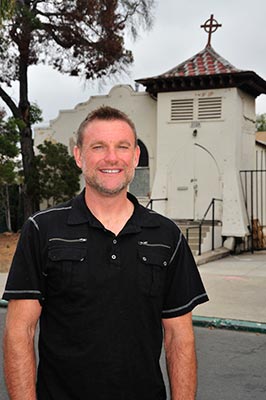 Gregory May in front of St. Luke's Chapel