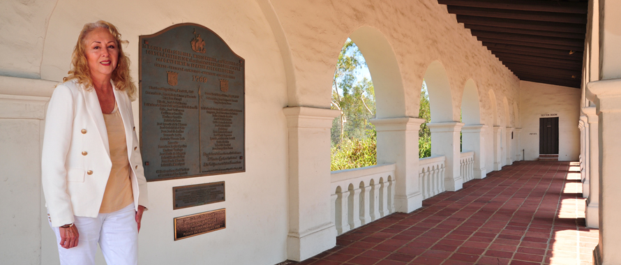 Connie Gunther standing in front of the descendants plaque in Presidio Park