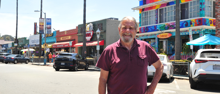 Frank Gormlie standing in the middle of Newport Avenue in Ocean Beach