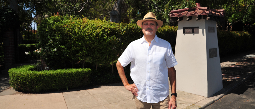Barry Hager in front of the Inspiration Heights historic district pillar